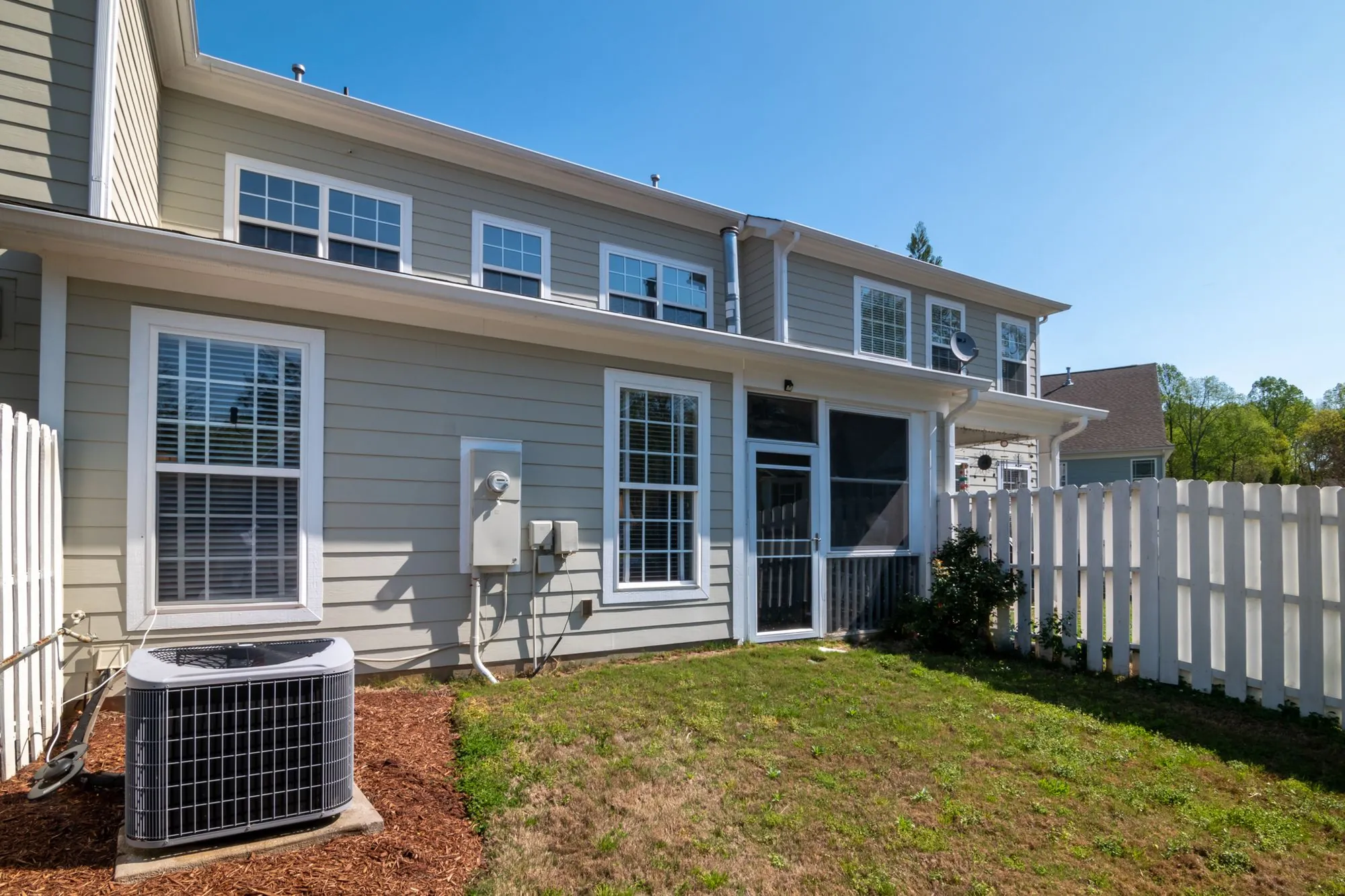 The gutter line running along the eaves of a sided suburban house